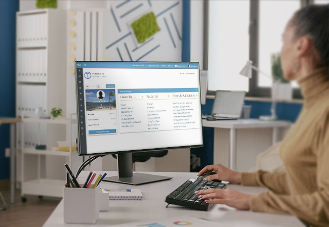 Woman using computer with isolated green screen at desk